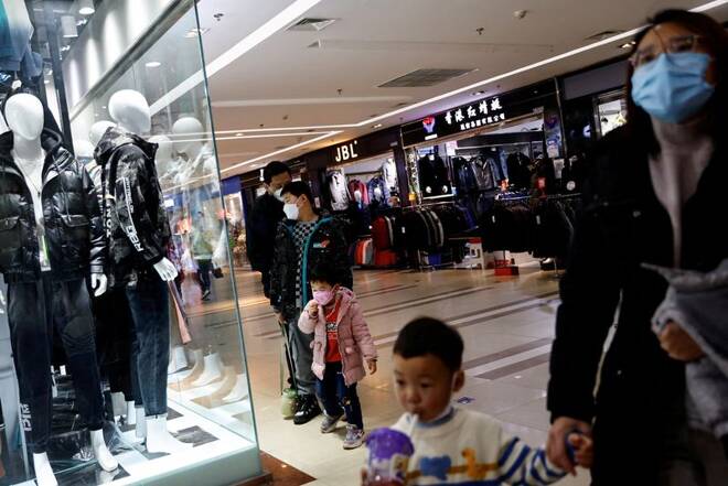 Customers shop at a mall ahead of the Chinese Lunar New Year, in Beijing