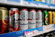 Cans of Budweiser beer are displayed on a supermarket shelf in Shanghai