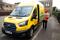 Senior Courier for DHL, Christopher Brownbill, delivers packages from a Ford E-Transit in London