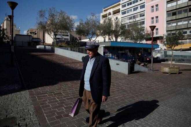 A man makes his way to the main food market, in Athens
