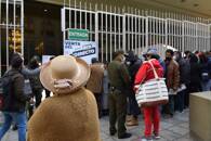 People stand outside Bolivia's Central Bank to buy U.S. Dollars, in La Paz