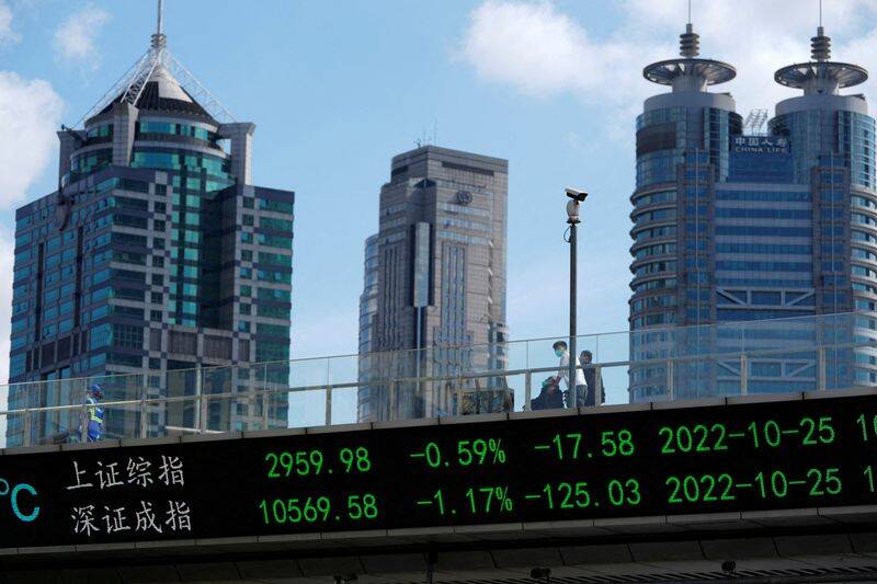 An electronic board shows Shanghai and Shenzhen stock indexes