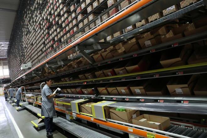 Workers handle cosmetic products at Natura's distribution center in Sao Paulo