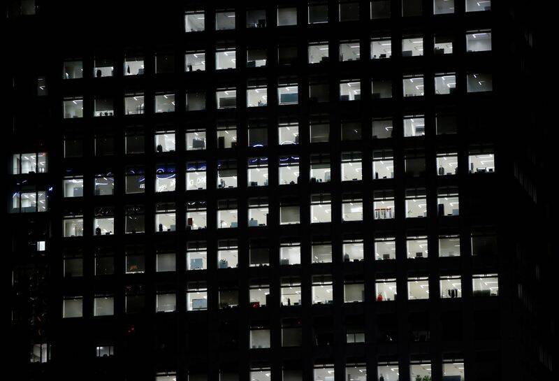 Office lighting is seen through windows of a high-rise office building in Tokyo