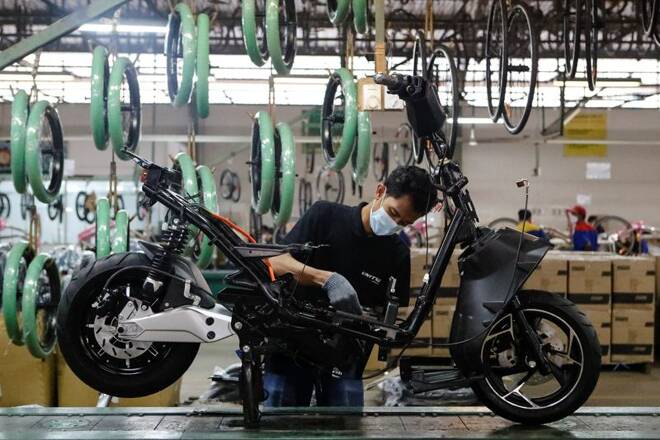 Employee works at the assembly line of an electric motorcycle at the United E-Motor factory in Bogor