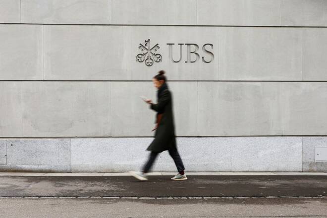 People walk near the Swiss bank UBS in Zurich