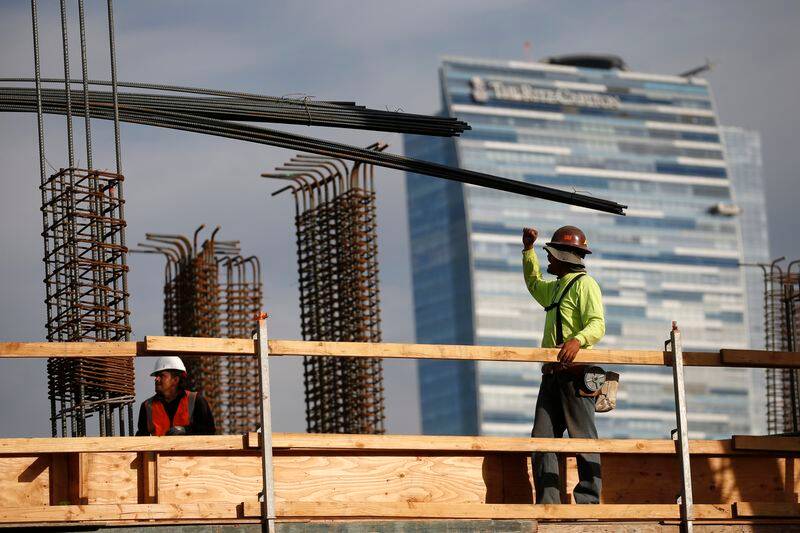 Men work on a construction site for a luxury apartment complex in downtown Los Angeles