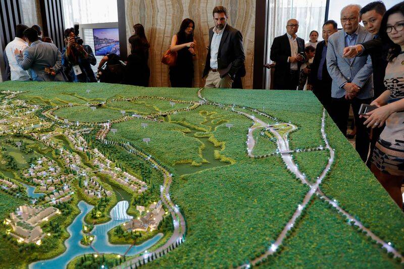 Visitors look at the models of Trump Residences Lido during the pre-launch of the Trump Residences, in Jakarta