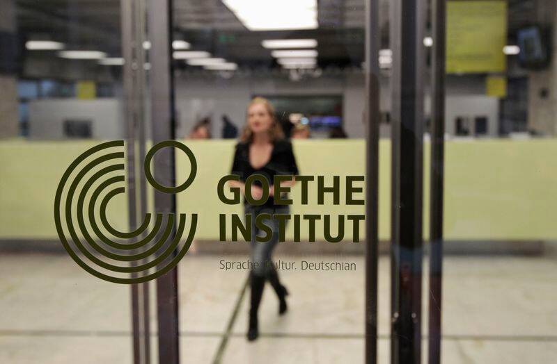 A woman walks inside the Goethe-Institut in Athens