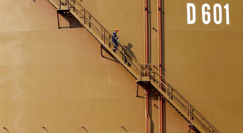 A worker walks down the stairs of an oil tank at Turkey's Mediterranean port of Ceyhan
