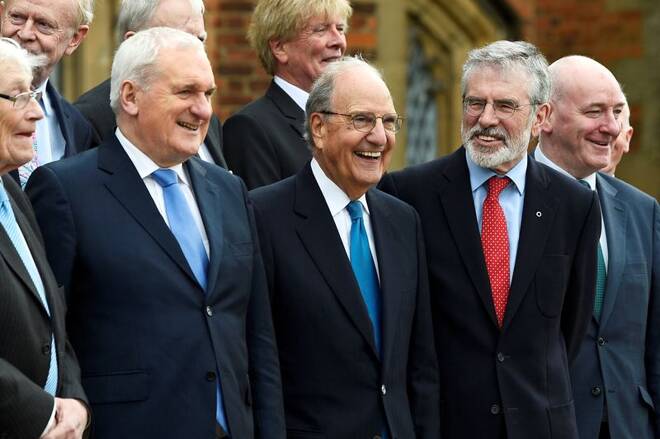 Bertie Ahern, former U.S. Senator George Mitchell and Gerry Adams stand with others for a group photograph at an event to celebrate the 20th anniversary of the Good Friday Agreement, in Belfast