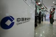 A customer waits at a counter of a branch of China Construction Bank Corp (CCB) at its headquarters in Beijing, China