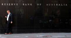 A man smokes next to the Reserve Bank of Australia headquarters in central Sydney