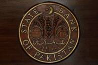 A logo of the State Bank of Pakistan (SBP) is pictured on a reception desk at the head office in Karachi