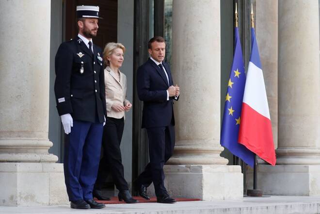 French President Emmanuel Macron talks with European Commission president-elect Ursula Von der Leyen as she leaves at the Elysee Palace in Paris