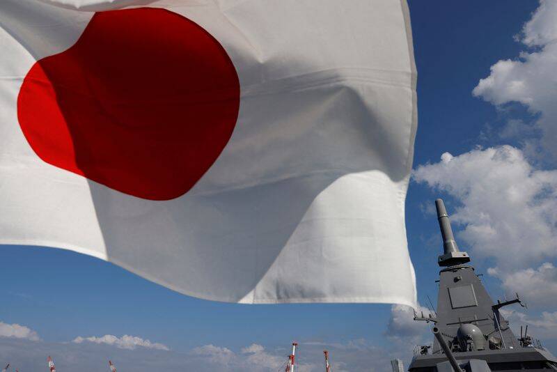 Japan's naval ship ‘Mogami’, featuring stealth capability, is seen next to Japan’s national flag at the Japan Maritime Self-Defense Force (JMSDF) naval base in Yokosuka