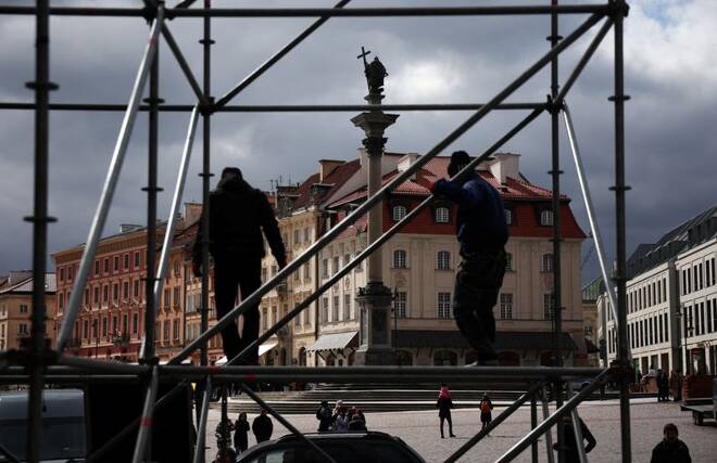 Workers assemble a screen for the audience for the visit of Ukraininan President Volodymyr Zelenskiy tommorow, in front of the Royal Castle in the Old Town in Warsaw
