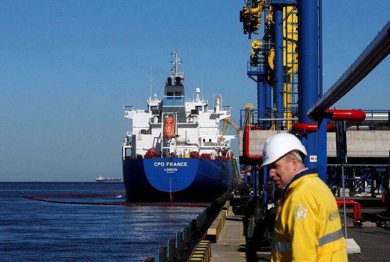 Oil is pumped into an oil tanker at the Ust-Luga oil products terminal in the settlement of Ust-luga