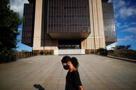 A woman walks in front the Central Bank headquarters building in Brasilia