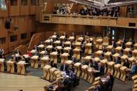 Scotland's First Minister Humza Yousaf takes questions from lawmakers, in Edinburgh