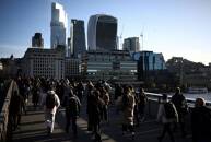 People walk across London Bridge during the morning rush hour
