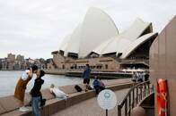 Chinese tourists pose for photographer near the Sydney Opera House