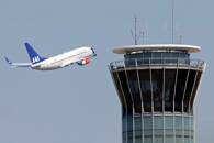 A Scandinavian SAS airline passenger plane flies near the air traffic control tower at Roissy airport, near Paris