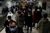 People walk at a subway station during rush hour in Beijing