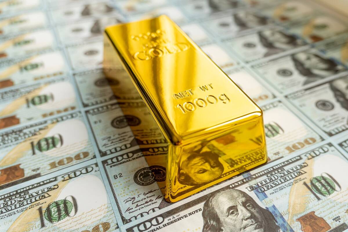 Gold bullion on US Dollar bills, FX Empire