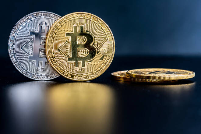 Bitcoins on a table, FX Empire