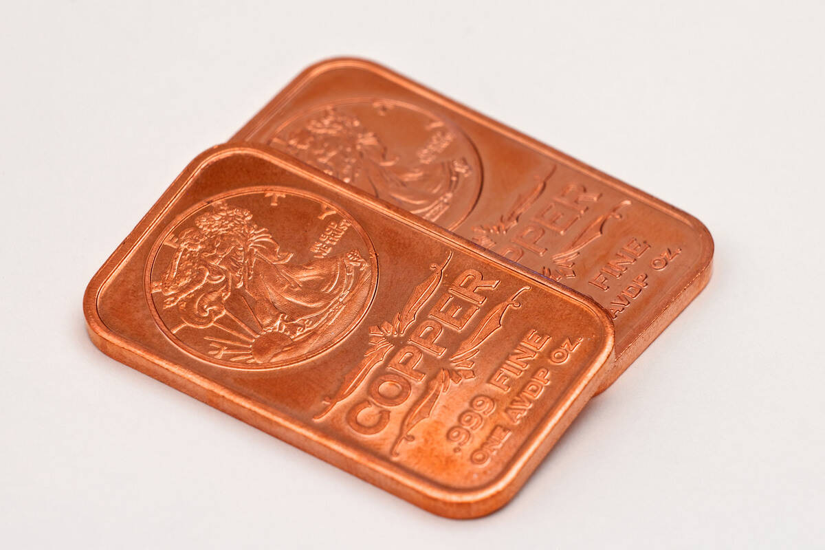 Two 1 ounce fine copper bars on white background. FX Empire