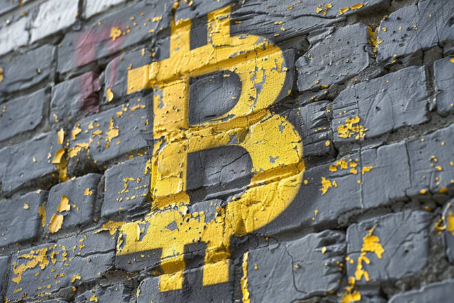 Bitcoin symbol on the wall. FX Empire