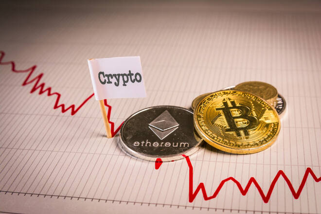 Bitcoin and Ethereum coins on bearish chart. FX Empire