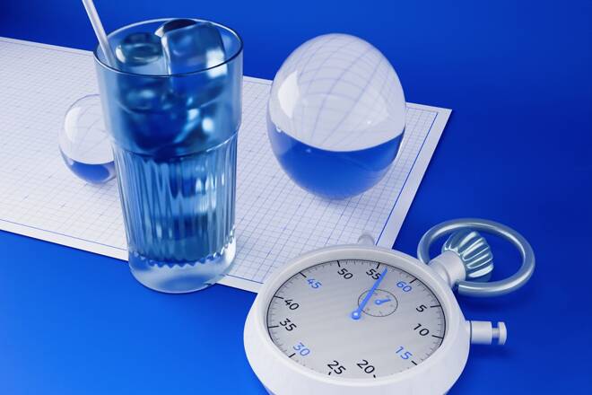 Stopwatch, glass of water and glass balls on graph paper. FX Empire