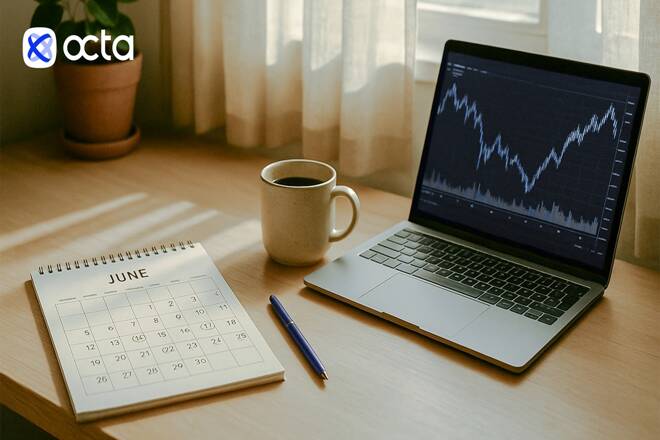 Octa plaftorm in a laptop, calendar, pencil and cup of coffee. FX Empire