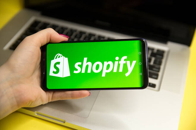 Shopify logo in smartphone. FX Empire