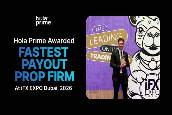 A composite image on a black background celebrating an award for Hola Prime. On the left, white and blue text reads "Hola Prime Awarded FASTEST PAYOUT PROP FIRM At iFX EXPO Dubai, 2026," with the Hola Prime logo above it. On the right, a man in a black suit stands in front of a purple and white backdrop featuring a stylized camel illustration and the words "THE LEADING ONLINE TRADING." He is smiling and holding a clear glass award. In the bottom right corner is the "iFX EXPO DUBAI" logo.