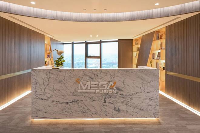 Modern office reception desk made of white marble with the 'MEGA FUSION' logo in front of large windows overlooking a city skyline.