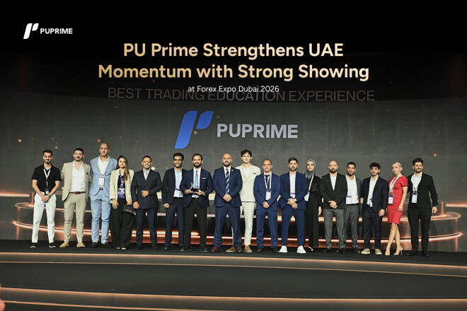 PU Prime team members pose on stage during Forex Expo Dubai 2026 holding an award for Best Trading Education Experience.