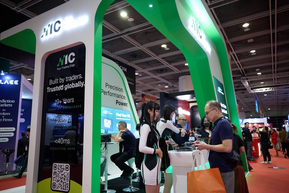 IC trading booth at iFX EXPO Asia 2026 in Hong Kong, featuring green and white branding, company representatives, and visitors interacting at the exhibition stand.
