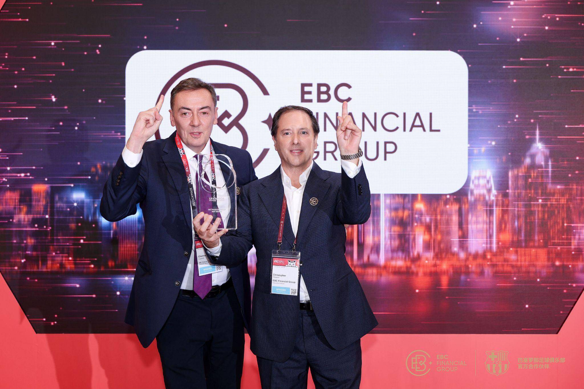 Image featuring Charles Lagares (General Counsel, EBC Financial Group (UK) Limited) and Christopher Stiegeler (Chief Operating Officer, EBC Financial Group (UK) Limited) on stage, holding the ‘Best Broker - APAC’ trophy.