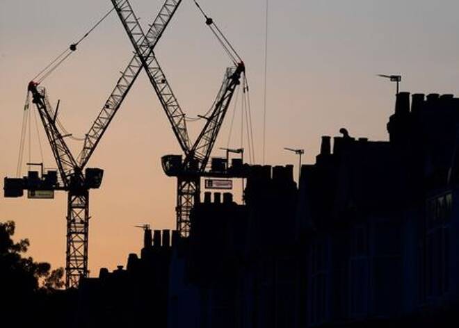 Construction cranes are seen on a residential building project behind homes in west London in Britain in this photograph taken on October 26