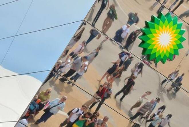 Spectators are seen reflected in a British Petroleum