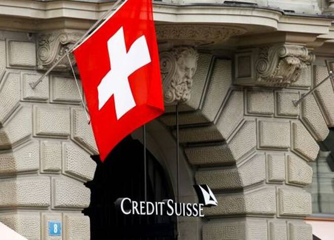 Switzerland's national flag flies above the logo of