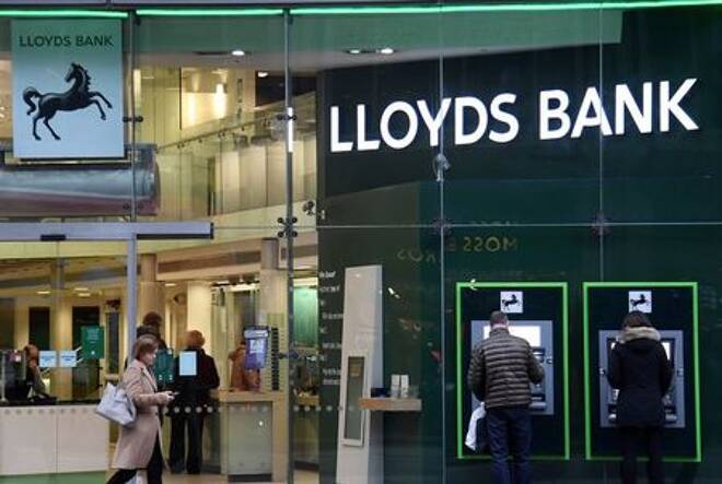 Customers use ATMs at a branch of Lloyds