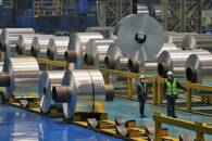 FILE PHOTO: Employees work at the production line of aluminium rolls at a factory in Zouping