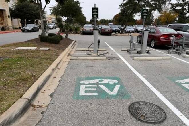 FILE PHOTO: An electric vehicle fast charging station is seen in the parking lot of a Whole Foods Market in Austin