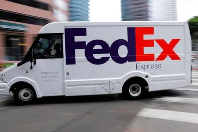A FedEx truck is driven through downtown in