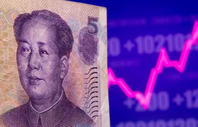 A Chinese Yuan banknote is seen in front of displayed