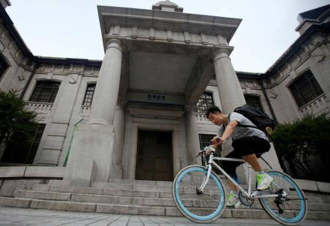 FILE PHOTO: A man gets on a bicycle in front of the Bank of Korea in Seoul